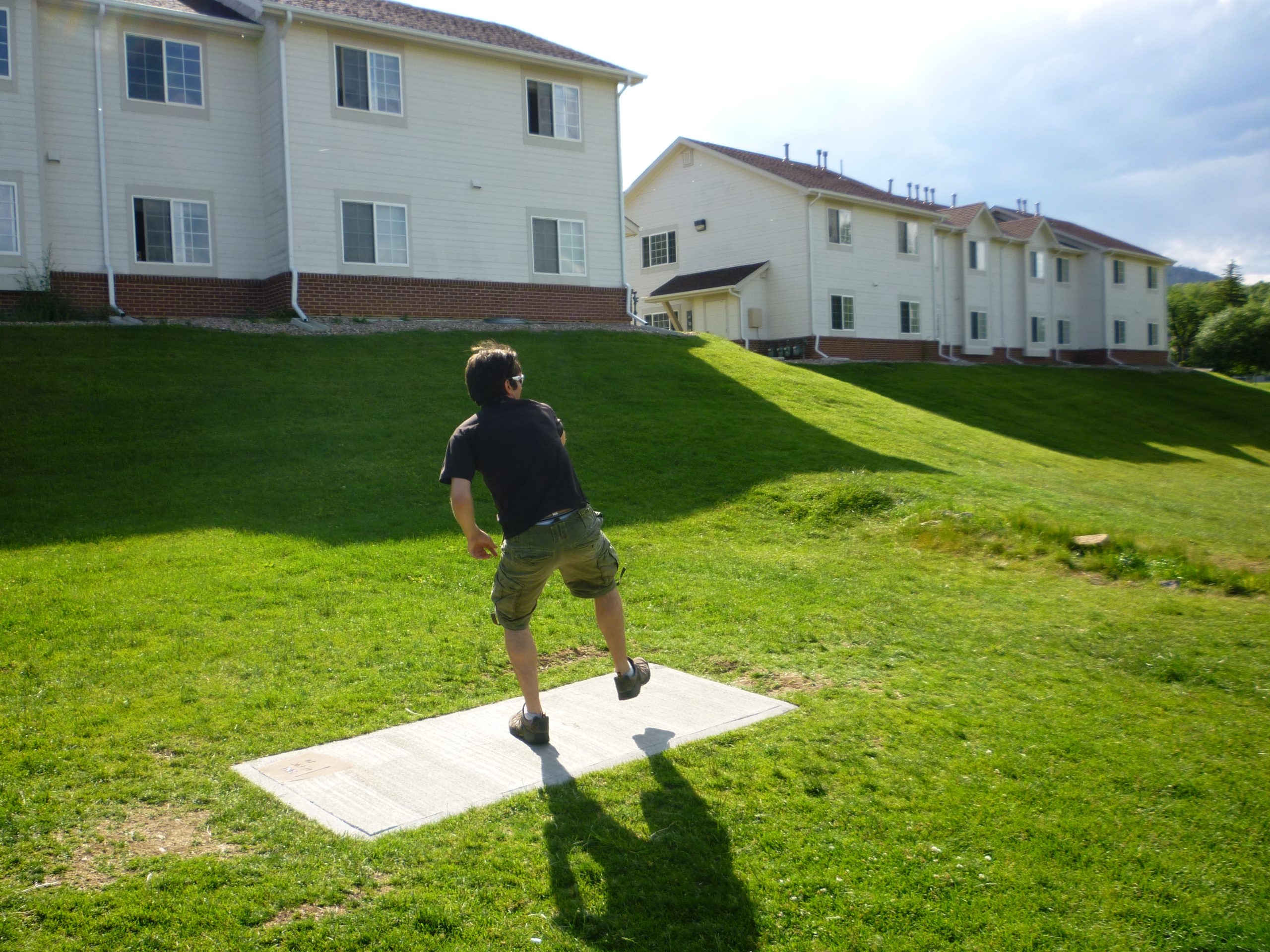 Player throwing a backhand drive from the tee pad